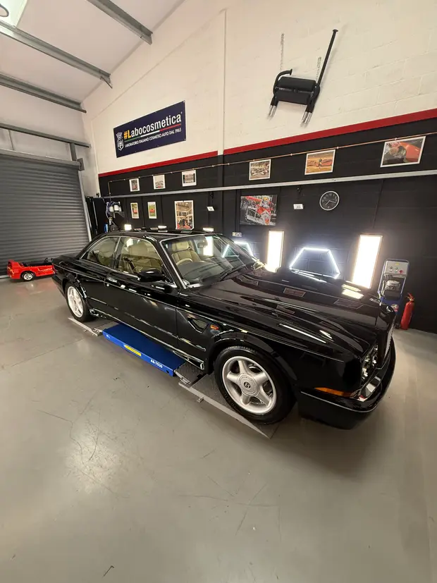 A black coupé inside the ALC Elite workshop