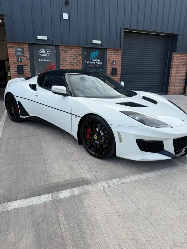 A white sports car outside the ALC Elite workshop unit