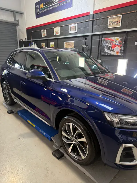 A dark blue estate car on the ramp in the ALC Elite workshop, with an interior view